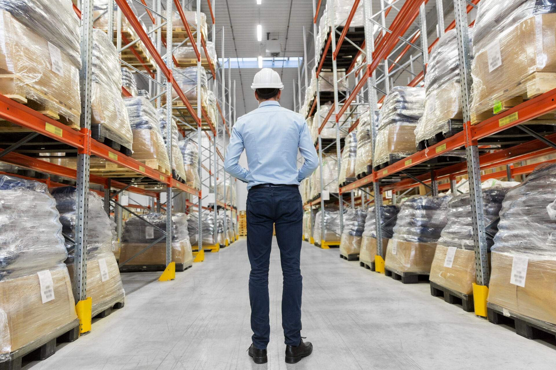 businessman in helmet at warehouse