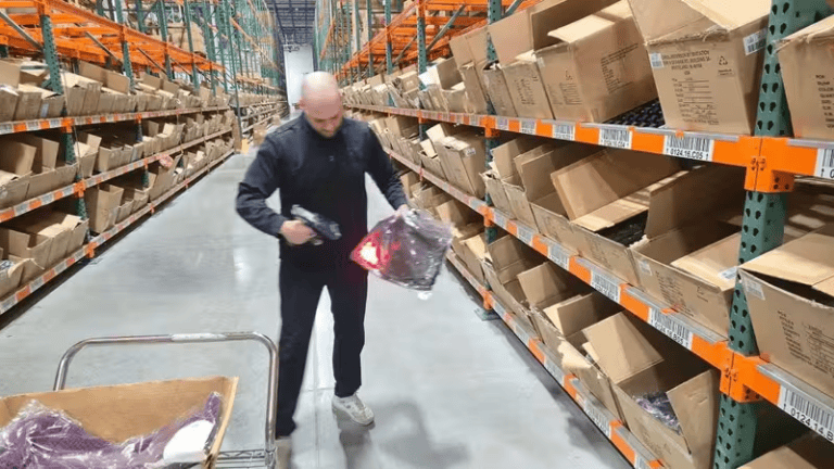 Warehouse worker scanning product in new distribution center.