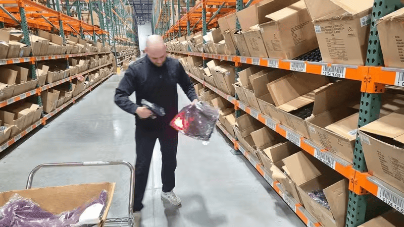 Warehouse worker scanning product in new distribution center.